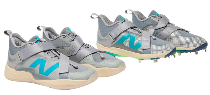 Side view of grey and blue New Balance baseball cleats and shoes.